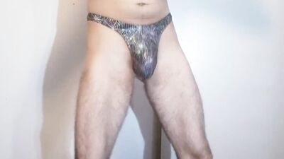 Handsome bloke is flashing his panties in front of the camera