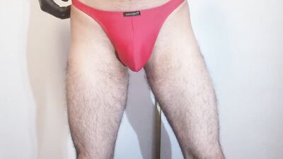 Handsome bloke is flashing his panties in front of the camera
