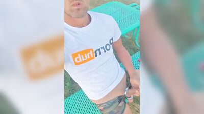 Horny dude strokes his dick in public while smoking a cigarette