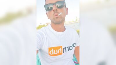 Horny dude strokes his dick in public while smoking a cigarette