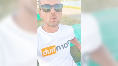 Horny dude strokes his dick in public while smoking a cigarette