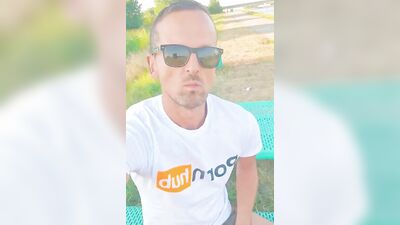 Horny dude strokes his dick in public while smoking a cigarette