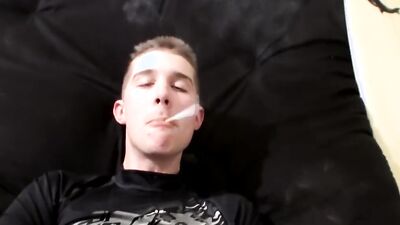 Straight lad is jerking his cock while he's smoking a cigarette