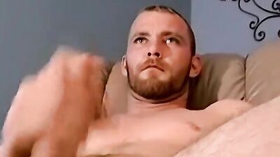 Lad jerks his huge cock in front of the tv