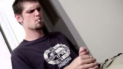 Straight bloke is jerking his hard cock while smoking a cigarette