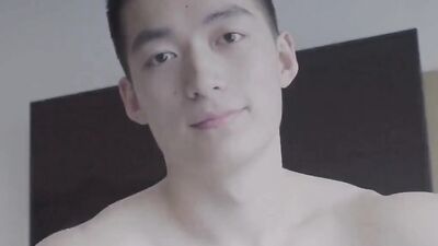 Good looking Asian lad is posing in front of the camera