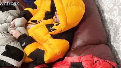 HumpingNorth Face Baltoro Down Jackets on Leather Couch Sofa.