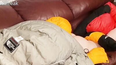 HumpingNorth Face Baltoro Down Jackets on Leather Couch Sofa.