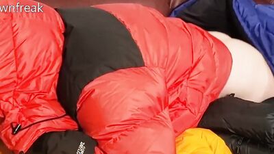 HumpingNorth Face Baltoro Down Jackets on Leather Couch Sofa.