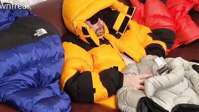 HumpingNorth Face Baltoro Down Jackets on Leather Couch Sofa.