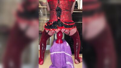 Crossdresser in corsage with mini skirt and latex stockings + fishnet stretches the anal pussy to the maximum with huge plugs