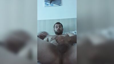 The guy jerks off a 20-centimeter dick and cums