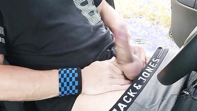Gay guy jerks off in the car wearing a cock ring and condom