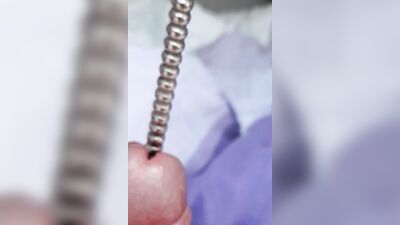 Sounding with a close up cum load through penis plug