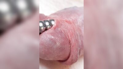 Sounding with a close up cum load through penis plug