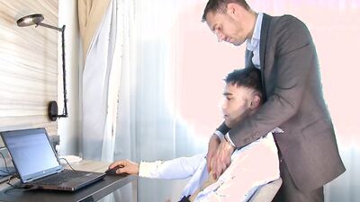 He gets sucked in the office by 2 guys.