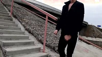 guy jerks off his dick under a traffic junction