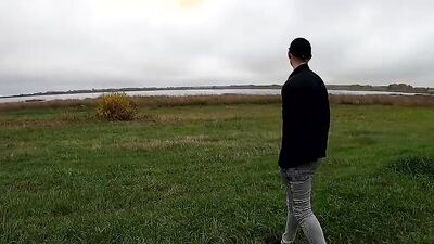 guy jerking off his dick by the lake