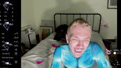 male camming model seducing viewer in his blue bedazzled superhero bodysuit (lol no homo)