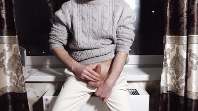 A young guy jerks off his dick and cums loudly