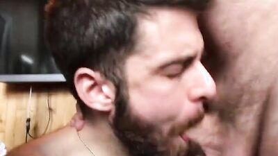 Cum thirsty bloke is sucking two cocks in the bar
