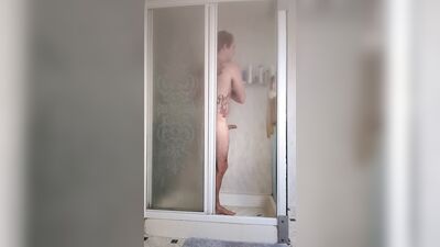 Young Lad Masturbates Bent Over in Hot Shower
