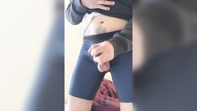 I take my cock out of my boxer shorts and jerk off with a condom while my neighbor sees me