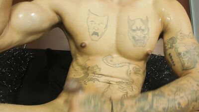 tattooed guy spitting his cock, and cum