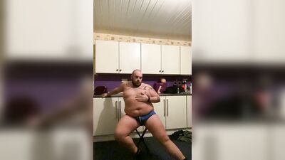 Daddy Bear strip teases wearing a jock, rides a dildo and cums