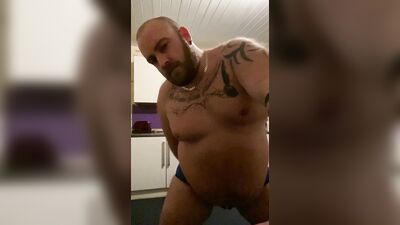 Daddy Bear strip teases wearing a jock, rides a dildo and cums