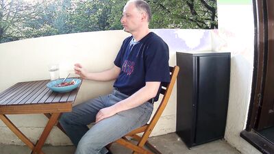 Man outside on the balcony eating lunch undress and starts wanking his penis is soon erect and he is naked as he wanks