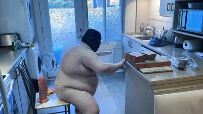 Pluged SuperChub cleans his kitchen