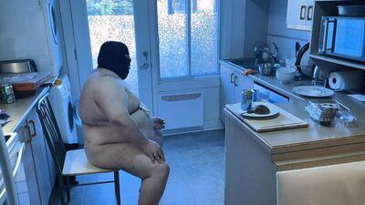 Pluged SuperChub cleans his kitchen