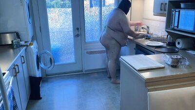 Pluged SuperChub cleans his kitchen
