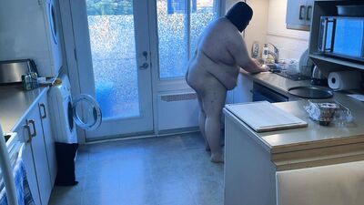 Pluged SuperChub cleans his kitchen