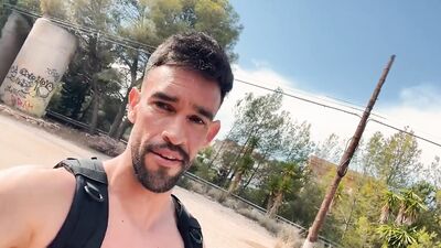 Fitness man walking fully naked on abandoned building