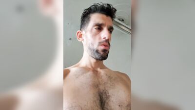 Latin stud with beautiful eyes caresses his pink cock and shows his muscular ass