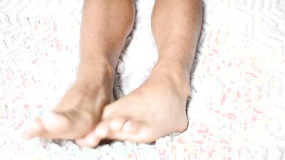 Delicious feet on a beautiful white sheet
