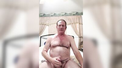 old man stroking big cock in bed