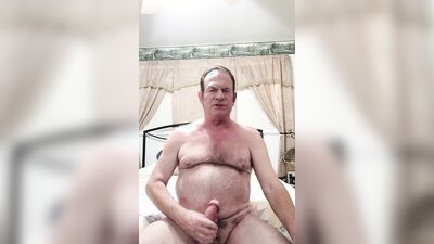 old man stroking big cock in bed