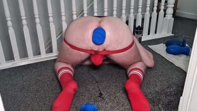 Toying around at top of stairs in red jockstrap and socks