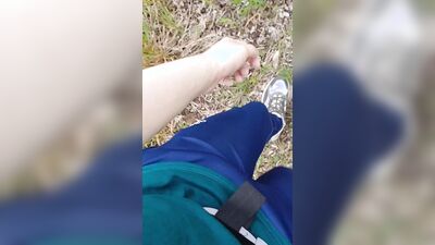 Sexy guy walks in the woods and jerks off his cock in his tight sweatpants