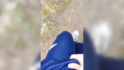 Sexy guy walks in the woods and jerks off his cock in his tight sweatpants