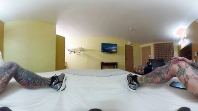 Tattooed bloke is riding his white dildo in VR video