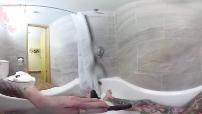 Tattooed bloke is riding his white dildo in VR video
