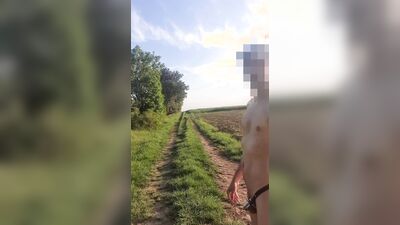 Completely exposed on a nude walk only with chastity cage