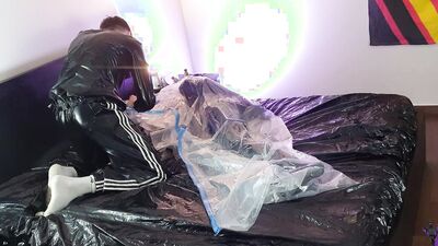 Rubberboy being tied up in a vacuumbag