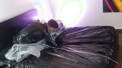 Rubberboy being tied up in a vacuumbag
