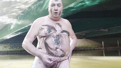 Fat pig Pascal masturbates in the humidity and mud under a bridge