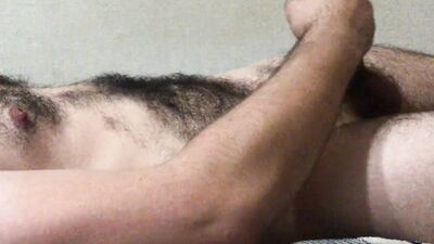 Hairy bisexual guy jerking off and moaning, cumming profusely and having an orgasm